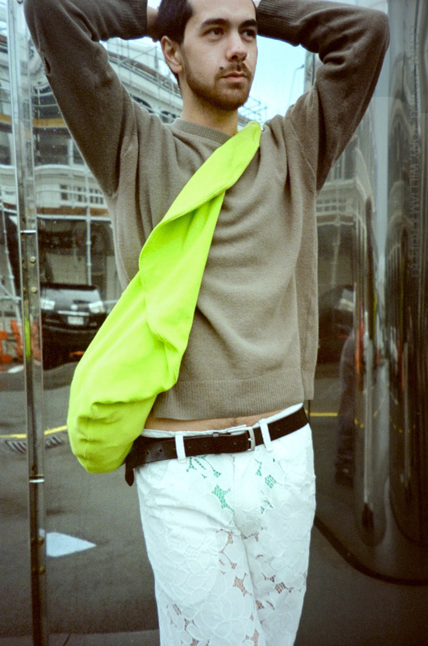 TJ wearing circle bag in safety yellow, Len Lye Govett Brewster Art Gallery. Aileen Chen.